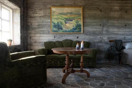 a living room with a table and two chairs at Jakob´s old farmhouse in Hvolsvöllur