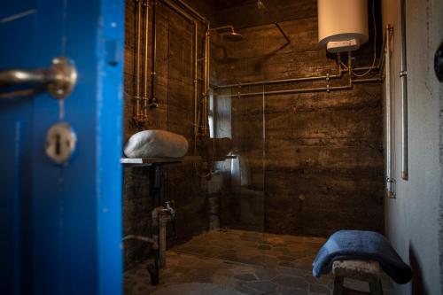 a shower with a glass door in a bathroom at Jakob´s old farmhouse in Hvolsvöllur