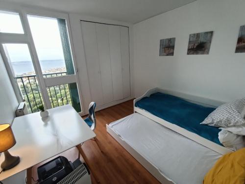a small bedroom with a bed and a window at VUE MER et montagne dans parc du roy d'espagne, Up to 7 people in Marseille