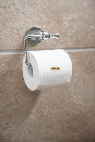 a roll of toilet paper on a holder in a bathroom at Settle inn Self Catering Units in Colchester