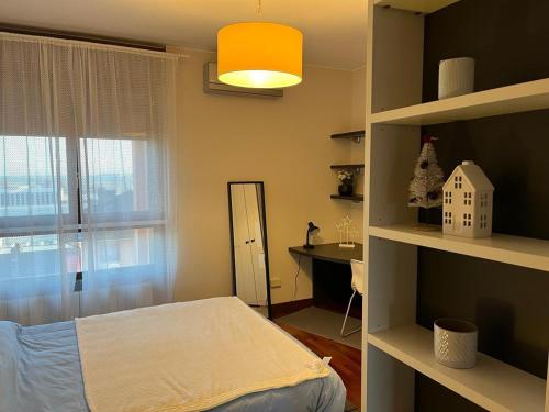 a bedroom with a bed and a window at Beslan360 in San Giuliano Milanese