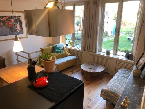 a living room with a couch and a table at Huis van Marietje in Aardenburg