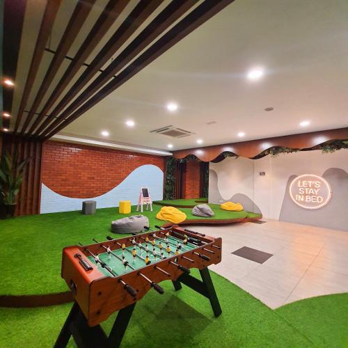 a room with a pool table in the middle of it at The Glass Homestay Putrajaya in Putrajaya