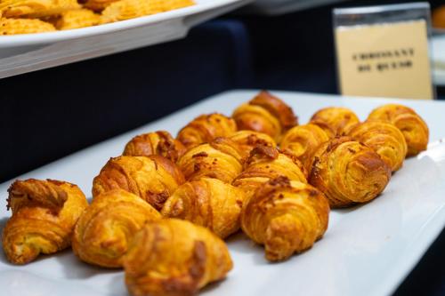 a pile of pastries on a white plate on a table at Hotel Calacoto in La Paz