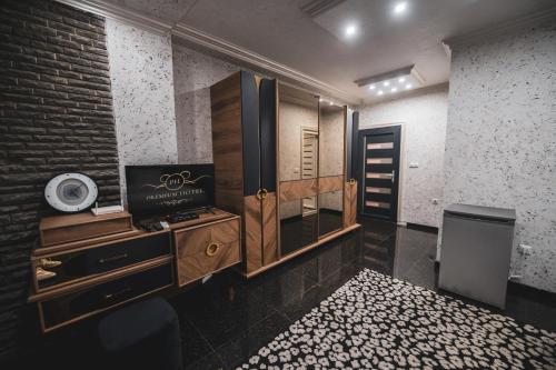 a room with a bathroom with a sink and a mirror at Hotel Premium in Prishtinë