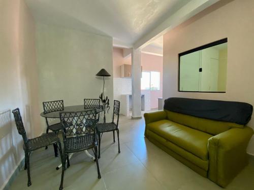 a living room with a couch and a table at Departamentos Imperial in Encarnación
