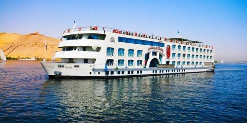a large white cruise ship in the water at One Love Guesthouse & Restaurant in Luxor