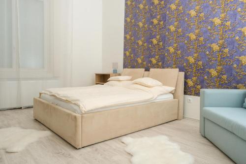 a bedroom with a bed and a floral wallpaper at Sky Apartment in Debrecen