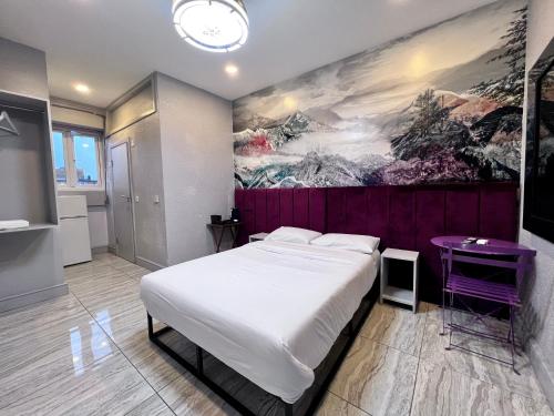 a bedroom with a bed and a painting on the wall at Shut Eyes in London