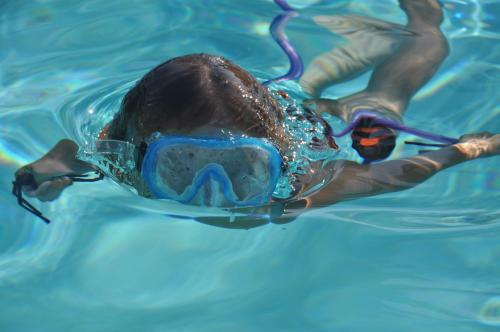 a person in a swimming pool with a mask on at Residence Le Acacie in Capoliveri