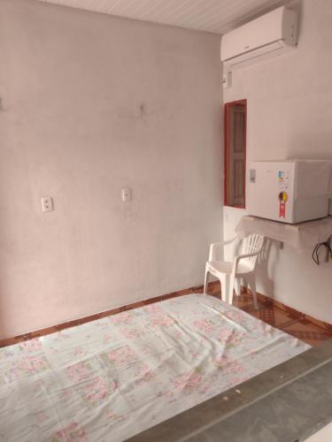 a room with a bed and a map on the wall at Pousada Sombra do Jambeiro in Alter do Chao