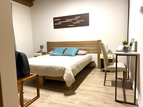 a bedroom with a bed and a desk and a tv at Equiturismo San Lorenzo - Villa KAMARA in Cammarata
