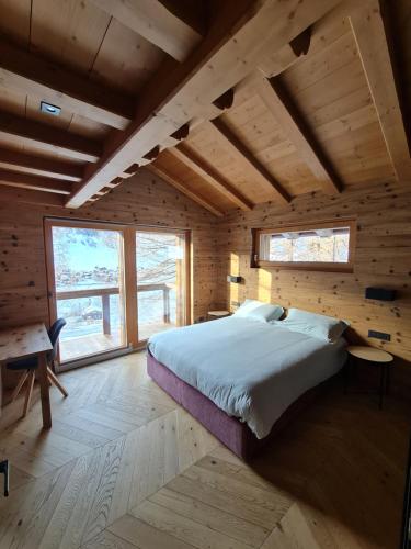 a bedroom with a bed in a wooden cabin at Blackberry Apartment in Livigno