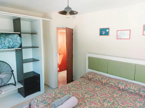 a bedroom with a bed and a closet at Jazmin del Cielo in Capilla del Monte