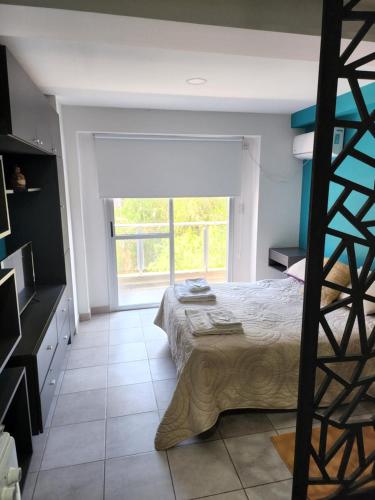 Ένα ή περισσότερα κρεβάτια σε δωμάτιο στο Buena Onda - departamento