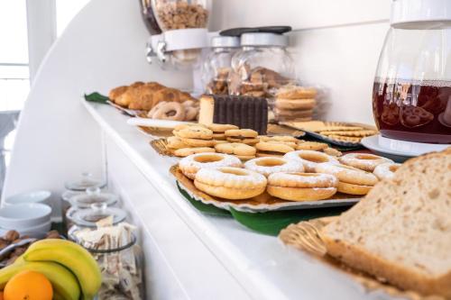 a shelf filled with different types of bread and pastries at New Pescara City b&b in Pescara