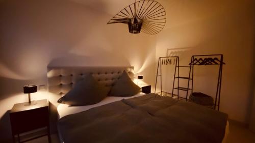 a bedroom with a large bed with a fan above it at PureNature Appartement in Obersontheim