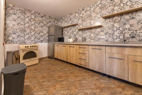 a kitchen with a sink and a stove at Ranger Chalet in Moieciu de Sus