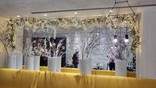 a room with a yellow table with trees and lights at Boutique Hotel Corso in Karlovy Vary