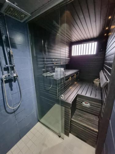 a small bathroom with a shower and a sink at Central Gem with Sauna - Big two-room apartment FREE PARKING in Tampere