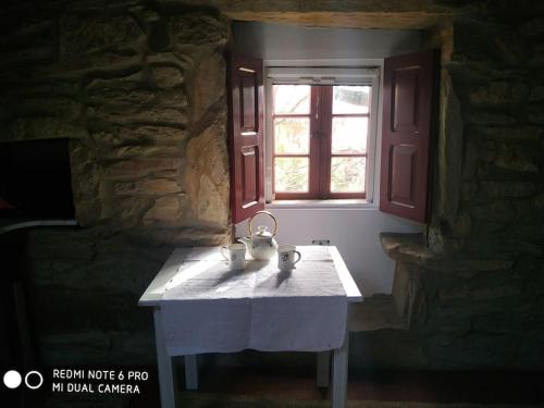 a table in a room with a window at Casita en Domaio - Moaña in Moaña