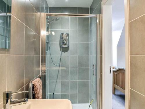 a bathroom with a shower with a toilet and a sink at ThreeStorey Townhouse - Free parking in Normanton