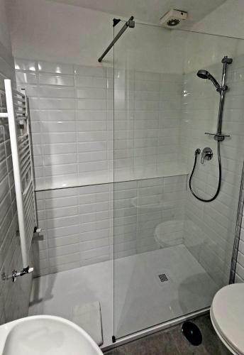 a bathroom with a glass shower with a toilet at Appartamento Piazza Navona in Rome