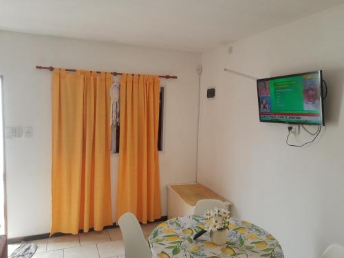 a dining room with a table and a television at Umi del sur in Mar del Plata