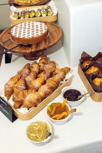 a table with various types of bread and other pastries at Casa Nostra Boutique Hotel & Spa in Palermo