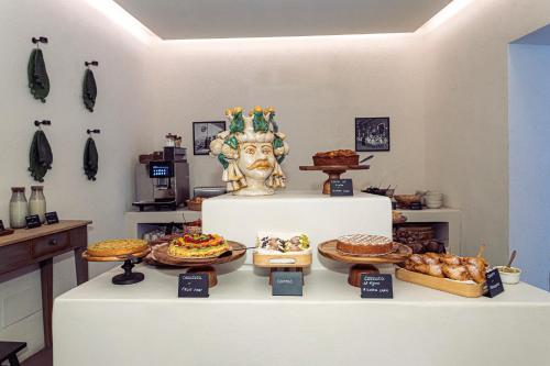 a bakery with various pastries and pies on a table at Casa Nostra Boutique Hotel & Spa in Palermo