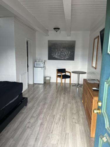 a living room with a bed and a table at Thunderbird Motel in Pocatello