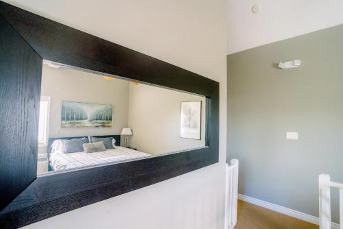 a bedroom with a large mirror on the wall at Hillside BLUE MTN Family Loft @ North Creek Resort in Blue Mountains