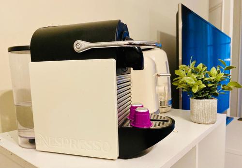 a black and white espresso machine sitting on a counter at Pompidou ROOM PARIS CENTRE in Paris