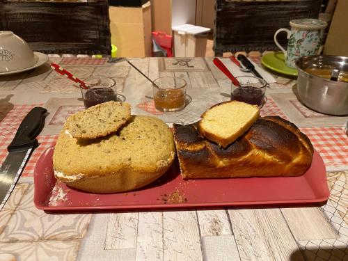 a loaf of bread on a red plate on a table at ZenViewStudios in Saint-Agil
