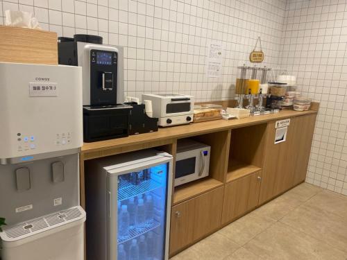 a kitchen with a counter with microwaves and appliances at Sodo Hotel in Paju