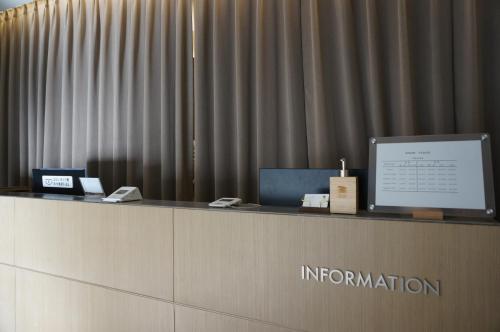 a reception desk with a computer on top of it at Sodo Hotel Paju in Paju