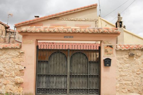 a building with a large gate in front of it at Villa Lucia in Castroserna de Abajo