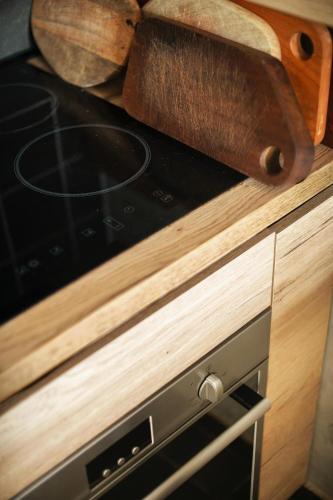 a stove top oven sitting inside of a kitchen at Kežman Mountain Houses in Kopaonik