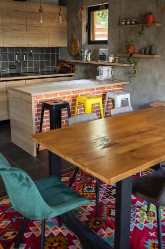 a dining room with a wooden table and chairs at Kežman Mountain Houses in Kopaonik