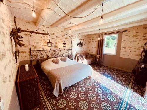 a bedroom with a white bed in a room with a window at Domaine Amourella in Lambesc