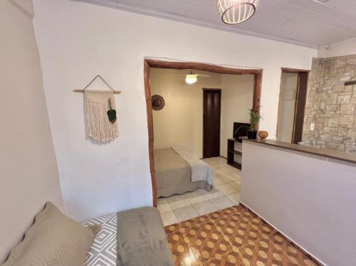 a living room with a bed and a mirror at Coco Suites in Abraão
