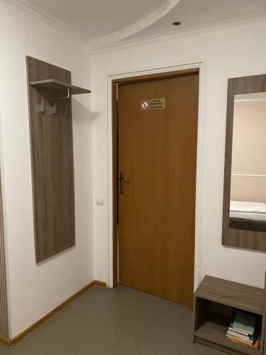 a brown door in a room with a mirror at Відпочинковий комплекс,міні готель Старий дворик in Lviv