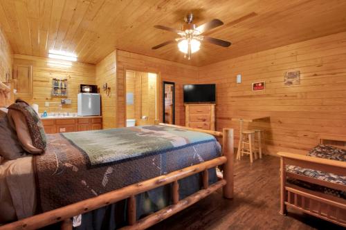 a bedroom with a bed and a ceiling fan at Arrow Creek Camp and Cabins in Gatlinburg