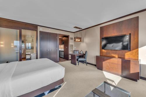 a hotel room with a bed and a flat screen tv at Vdara Studio Suite 011 Pool View FREE VALET Parking in Las Vegas