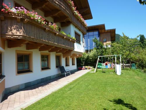 a house with a yard with a swing at Haus Moosanger in Oberau