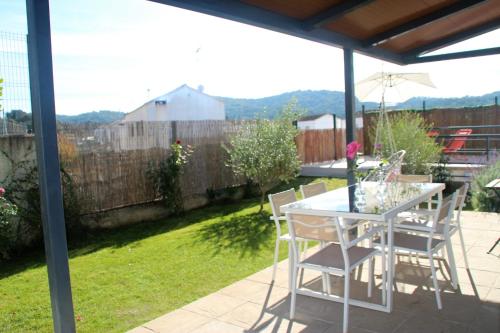 eine Terrasse mit einem weißen Tisch und Stühlen auf einem Hof in der Unterkunft Casa Rural Lavanda-San Nicolás del Puerto, Sevilla in San Nicolás del Puerto