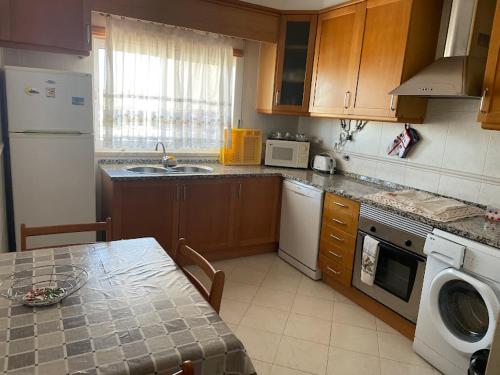 una cocina con una mesa y una encimera en t2 armação de pêra, en Armação de Pêra