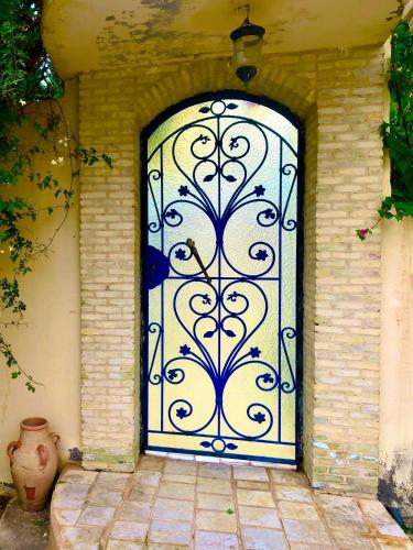 a door to a house with a vase in front of it at Dar dguech in Degache