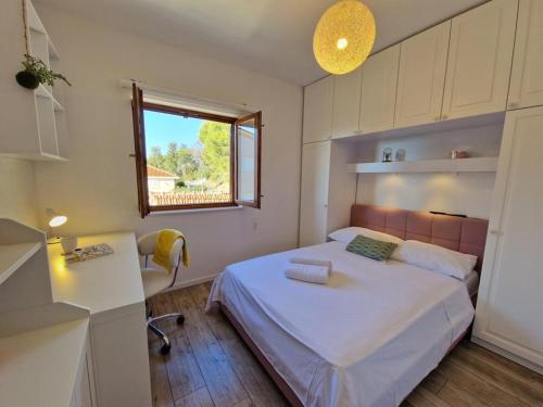 a small bedroom with a bed and a window at Apartment Ivana in Trogir