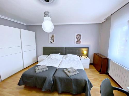 Postelja oz. postelje v sobi nastanitve Apartamentos Milán 1 wifi y parking gratuito
